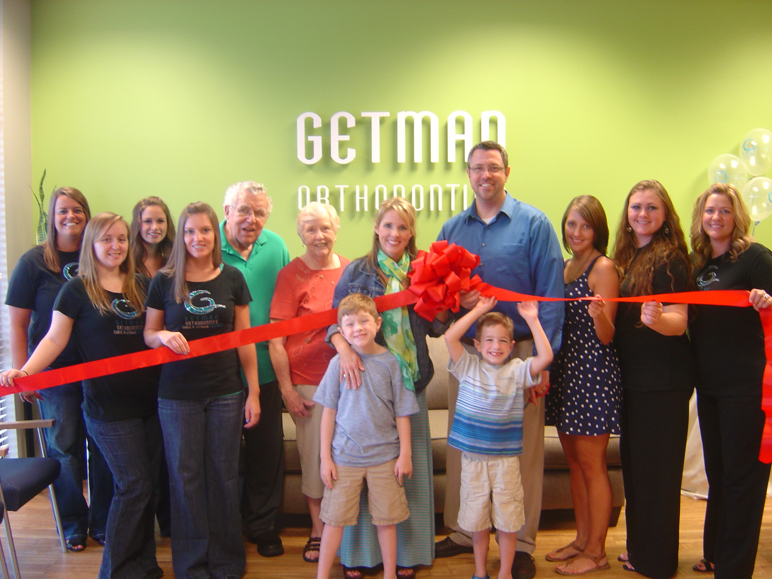 Getman family and staff celebrate Ribbon Cutting at new Arlington office-Jul13